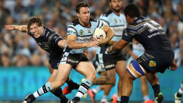Man of the match: James Maloney makes a break for the Cronulla Sharks against the North Queensland Cowboys.