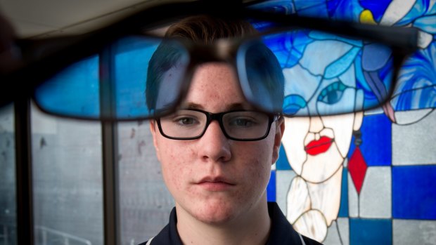 Silas Dewney, 14, says his coloured glasses have helped with his dyslexia. 