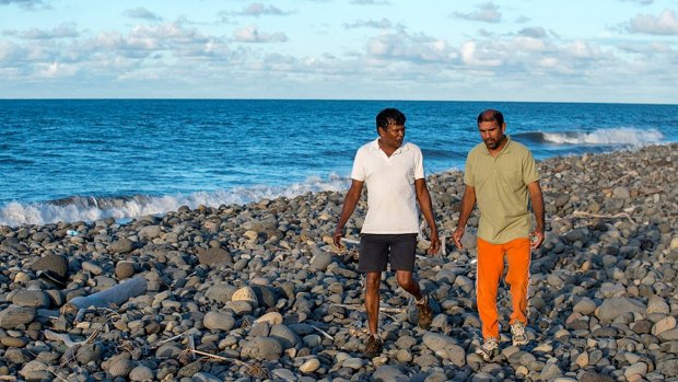 Johnny Begue, right, who found the plane debris, on the beach at Saint-Andre, with his friend Andre Tevane,  