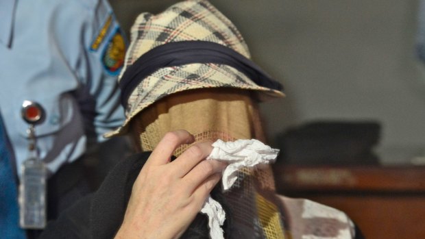 Corby, with her face covered by a veil and carrying a tissue to wipe away her tears, leaves Bali's Kerobokan jail in February 2014 after being granted parole.