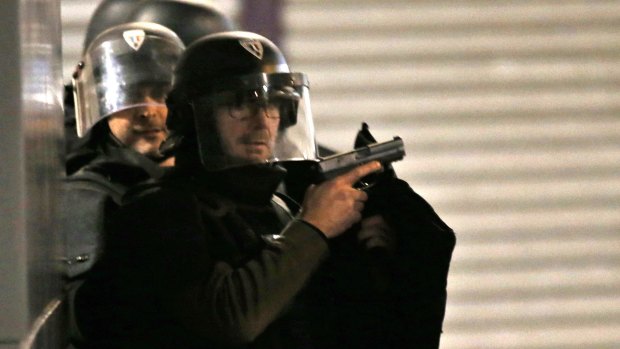 Armed police officers take up positions in Saint-Denis, Paris, early on Wednesday morning.