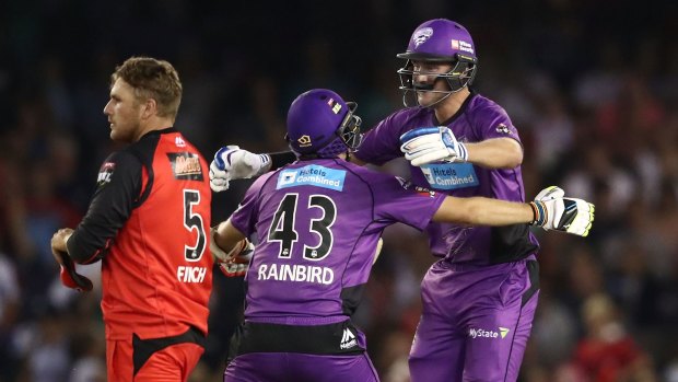 Stuart Broad of the Hurricanes is congratulated by teammate Sam Rainbird after hitting the winning runs as Renegades captain Aaron Finch looks on.