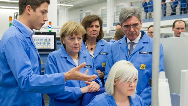 German Chancellor Angela Merkel visits Siemens electronics factory in Amberg, Germany, earlier this year.