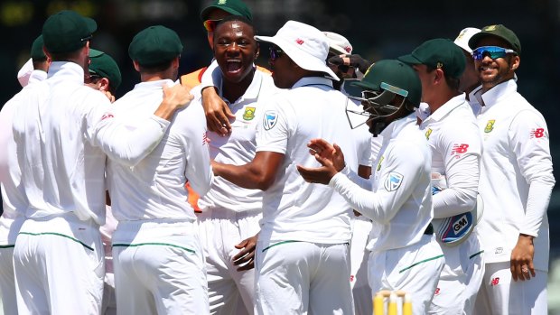 Testing times: South Africa celebrate after Kagiso Rabada snagged the the wicket of Mitch Marsh.