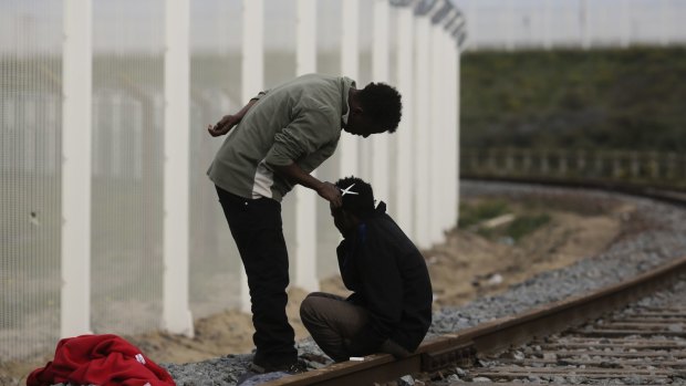 A migrant gives another a haircut near the migrant camp known as the new Jungle in Calais, France, on Tuesday.