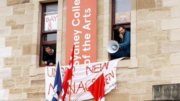 Students are seen from the windows of the administration offices of the Sydney College of Arts before they were removed.
