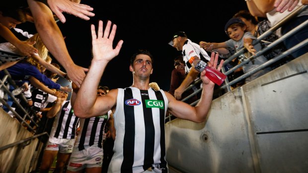 Handy win: Scott Pendlebury leads the Pies into the rooms on Saturday night.