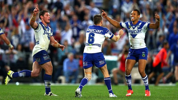 Celebration: Josh Reynolds celebrates the winning field goal with Moses Mbye as Josh Jackson rushes in after the NRL elimination final between the Bulldogs and the Dragons last year.