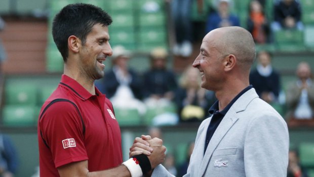 Novak Djokovic shakes hands with umpire Pascal Maria.