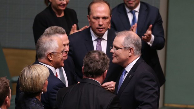 Treasurer Scott Morrison is congratulated by Prime Minister Malcolm Turnbull after he delivered his first budget.
