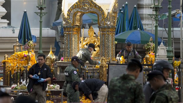 Police investigate the scene around the Erawan Shrine on Tuesday.