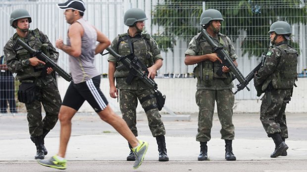 Brazilian soldiers stand on patrol during a security rehearsal of the Rio 2016 Olympic Games opening ceremony outside Maracana stadium on Sunday.