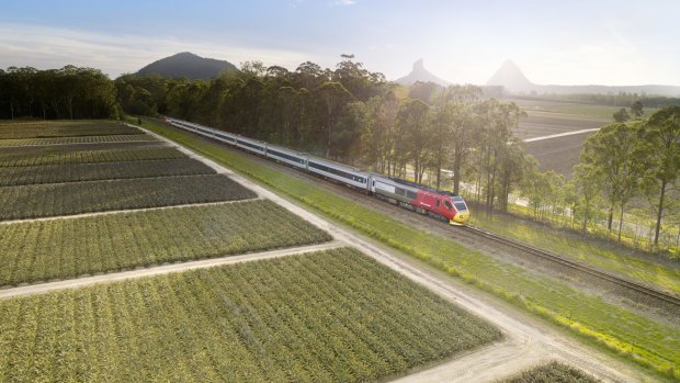 The Spirit of Queensland passes the Glass House Mountains.