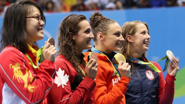 China's Fu Yuanhui, left, receives her bronze medal for the women's 100m backstroke.