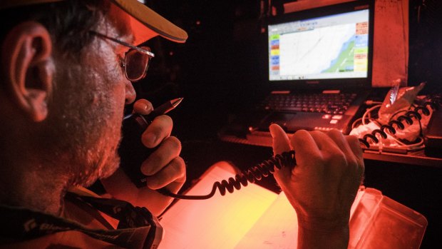Team Alvimedica navigator Will Oxley communicates with Team Vestas Wind after the ship struck a reef near Mauritius .