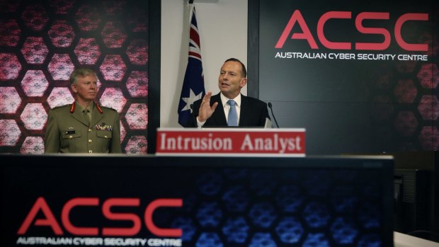Mr Abbott, pictured with General Stephen Day, announces a cyber security review.