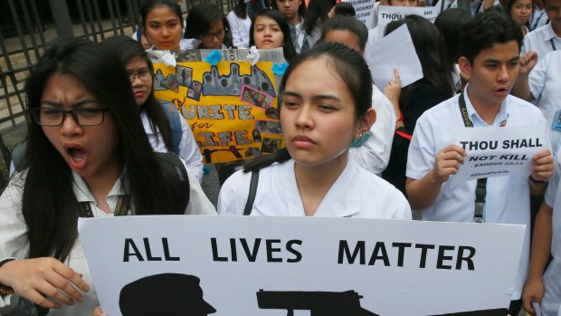 Filipino students display placards in protest of the killings being perpetrated in the unrelenting "War on Drugs" campaign of President Rodrigo Duterte.