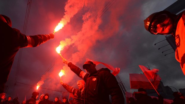 Demonstrators burn flares and wave Polish flags during the annual march to commemorate Poland's National Independence Day in Warsaw, Poland, in November.