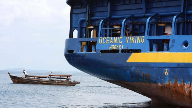 The Australian customs vessel the Oceanic Viking, carrying Sri Lankan asylum seekers, and a traditional Indonesian boat off Bintan Island, Indonesia in October 2009. 