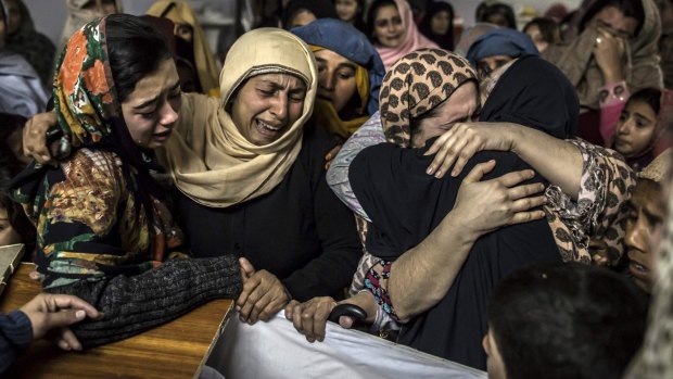 Bloodshed: Relatives mourn over the coffin of Mohammed Ali Khan, 15, after the school massacre in Peshawar.