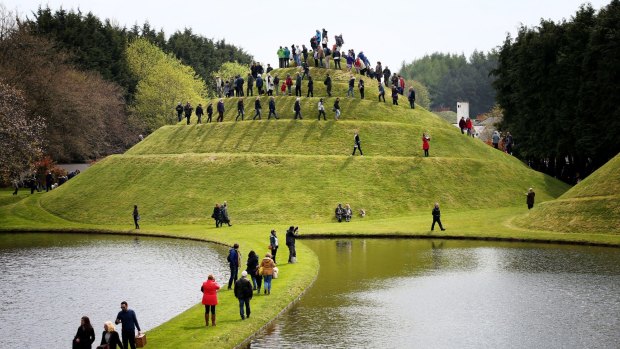 Visitors climb the Snail Mound in Charles Jenck's  Garden of Cosmic Speculation.