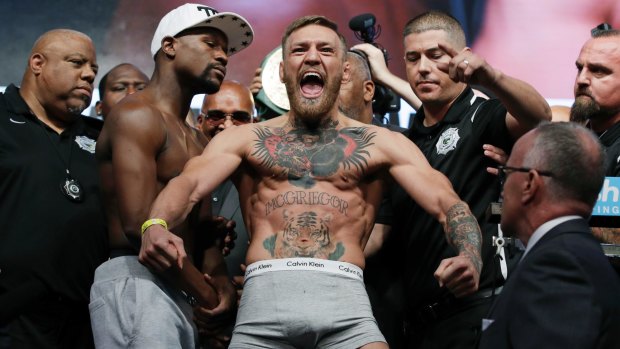 Conor McGregor eats up the spotlight in the weigh-in for his bout against Floyd Mayweather.
