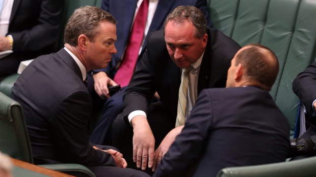 Agriculture Minister Barnaby Joyce consults with leader of the house Christopher Pyne and Prime Minister Tony Abbott during question time on Monday.