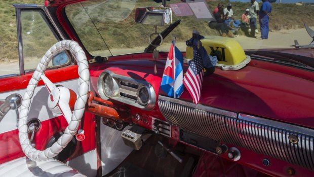 The stars and stripes and the Cuban national flag on the dashboard of a vintage American convertible in Havana on Thursday. 