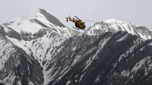 A rescue helicopter from the French Securite Civile flies over the French Alps during a rescue operation after the crash of an Airbus A320, near Seyne-les-Alpes. 144 passengers and 6 crew member died when the Airbus A320 slammed into the French Alps at high-speed.