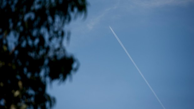 Contrails behind a plane flying over Canberra.