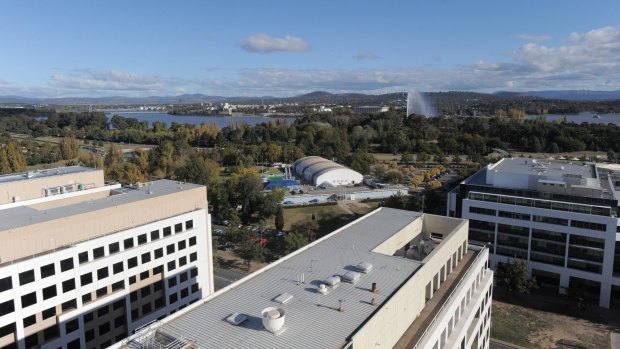 A view of Civic Pool, with Parkes Way and Lake Burley Griffin in the background.