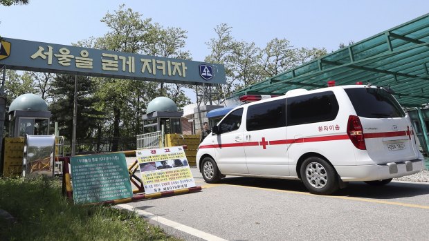 A military ambulance enters into a reserve forces training camp in Seoul, South Korea Wednesday, May 13, 2015. A South Korean reserve soldier went on a shooting spree on Wednesday.