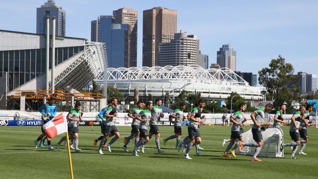 On the move: Socceroos 
players go through their paces at Collingwood’s training ground on Saturday. 