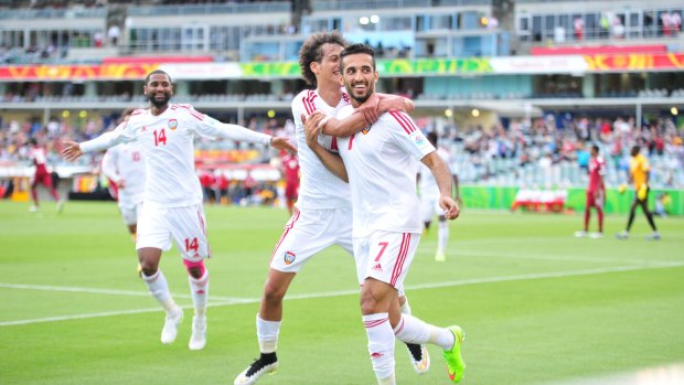 United Arab Emirates players Omar Abdulrahman, centre, and Ali Ahmed Mabkhout, right, celebrate a goal.