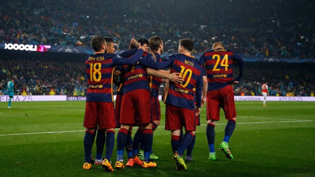 Change of scene? Barcelona players celebrate a second goal against Arsenal. 