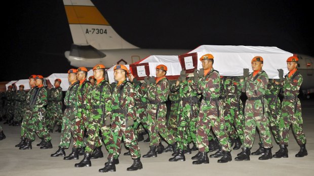 Indonesian Air Force soldiers carry the coffins of some of the victims of the Air Force C-130 Hercules aircraft, which crashed in Medan, after they arrived in Halim Airbase in Jakarta, Indonesia.