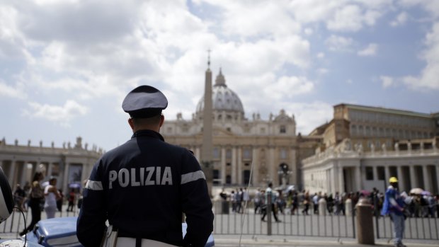 A police officer patrols outside St Peter's Square in the Vatican, Rome. Islamic extremists suspected in a bomb attack in a Pakistani market that killed more than 100 people had also planned an attack against the Vatican in 2010 that was never carried out, an Italian prosecutor said on Friday.