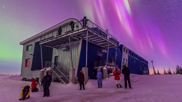 Tourists enjoy the start of a fine display of Northern Lights at the Churchill Northern Studies.