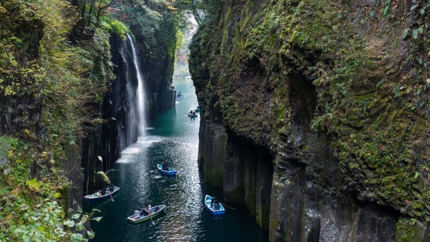 The picturesque Takachiho Gorge is a lava-walled chasm looking down on the turquoise river flowing through it.