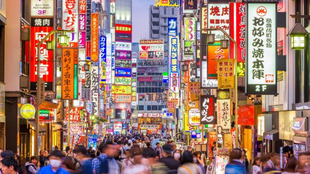 Crowds pass through Kabukicho in the Shinjuku district. The area is an entertainment and red-light district. 