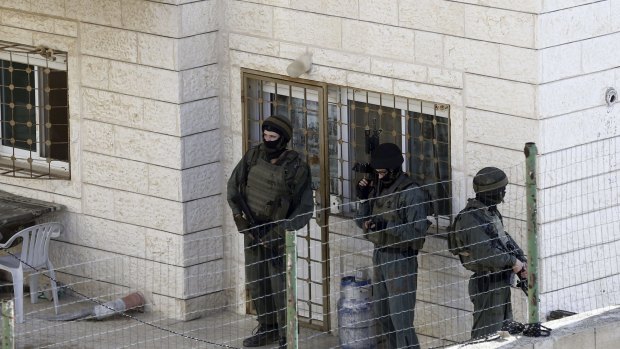 Israeli troops outside the Abu Jamal home in the aftermath of the attack.