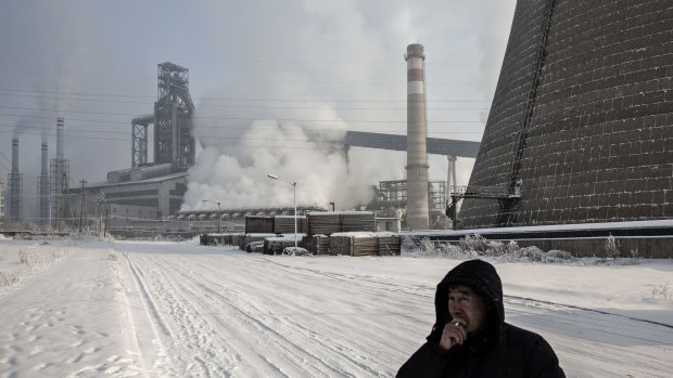 A man smokes a cigarette near a Tonghua Iron & Steel's plant in Jilin province. Pressure on media comes as the Communist Party faces rising criticism over its handling of the slowing economy.