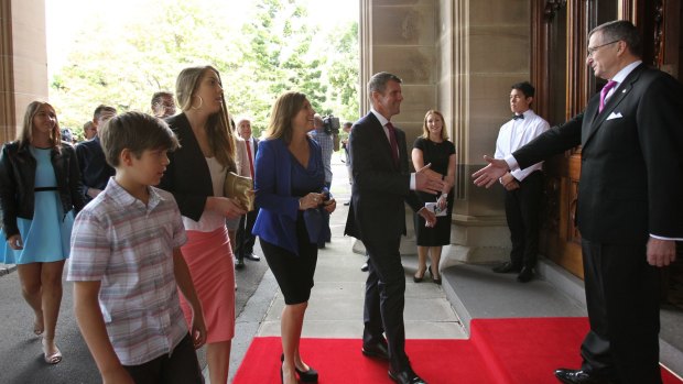 Premier Mike Baird arrives at Government House with his family.