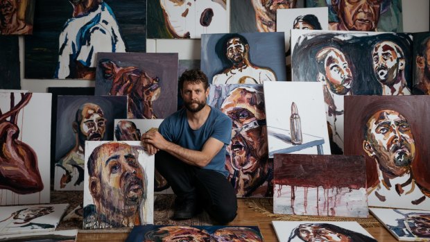 Artist Ben Quilty surrounded by works painted by Myuran Sukumaran, which will be exhibited at Campbelltown Arts Centre as part of the 2017 Sydney Festival.