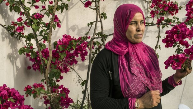 Hamida Ajengui, who was just 21 when she was arrested and beaten by Tunisia's state police, in the front yard of her home in Tunis in 2015.