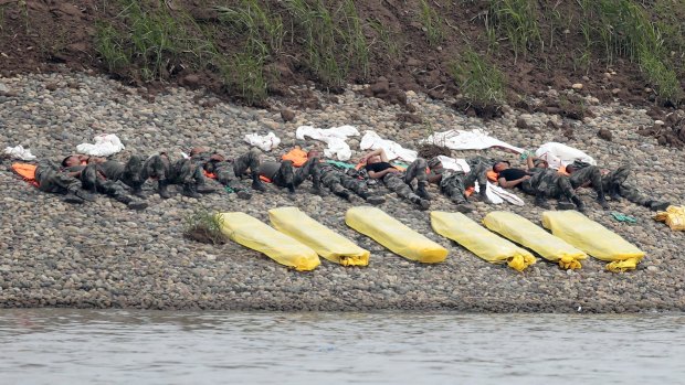 Rescue workers rest on the bank of the Yangtze River.