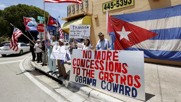 Protesters demonstrate against the reopening of the US embassy in Havana, in the Little Havana neighborhood in Miami, Florida August 14, 2015. U.S. Secretary of State John Kerry on Friday presided over a ceremony raising the U.S. flag over the newly reopened American embassy in Havana, Cuba.   REUTERS/Joe Skipper