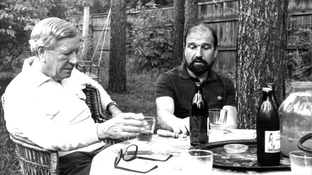 Kim Philby (left) and George Blake talk over a bottle of wine, July 1979.