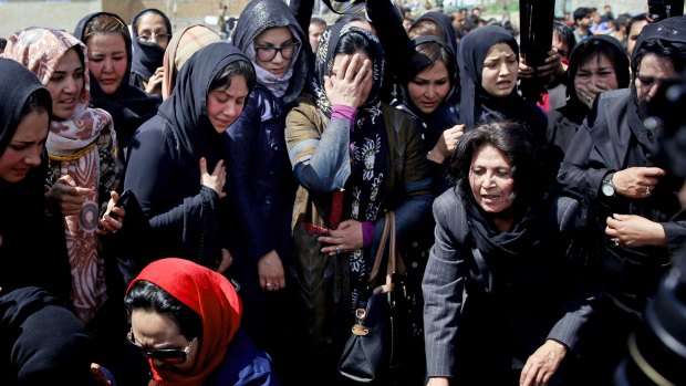 Afghan women are routinely subjected to sexism; here a group of Afghan women mourn a mentally-ill woman who was beaten and killed by a mob last year. 