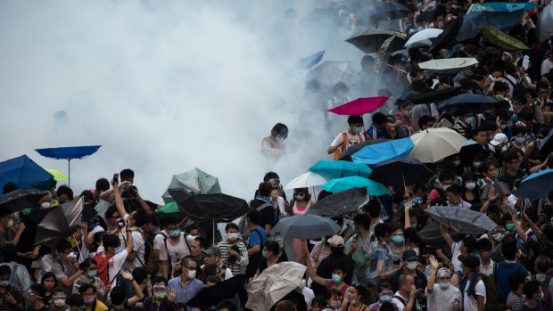 Police fire tear gas at demonstrators during a protest near central government offices in Hong Kong.